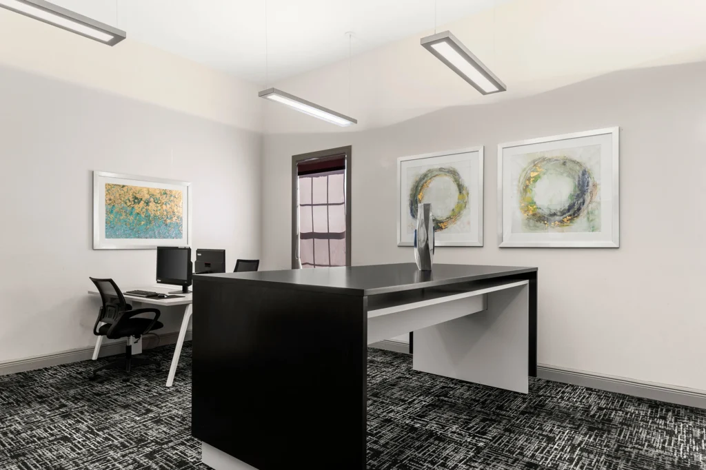 Leasing office with desk and chairs.